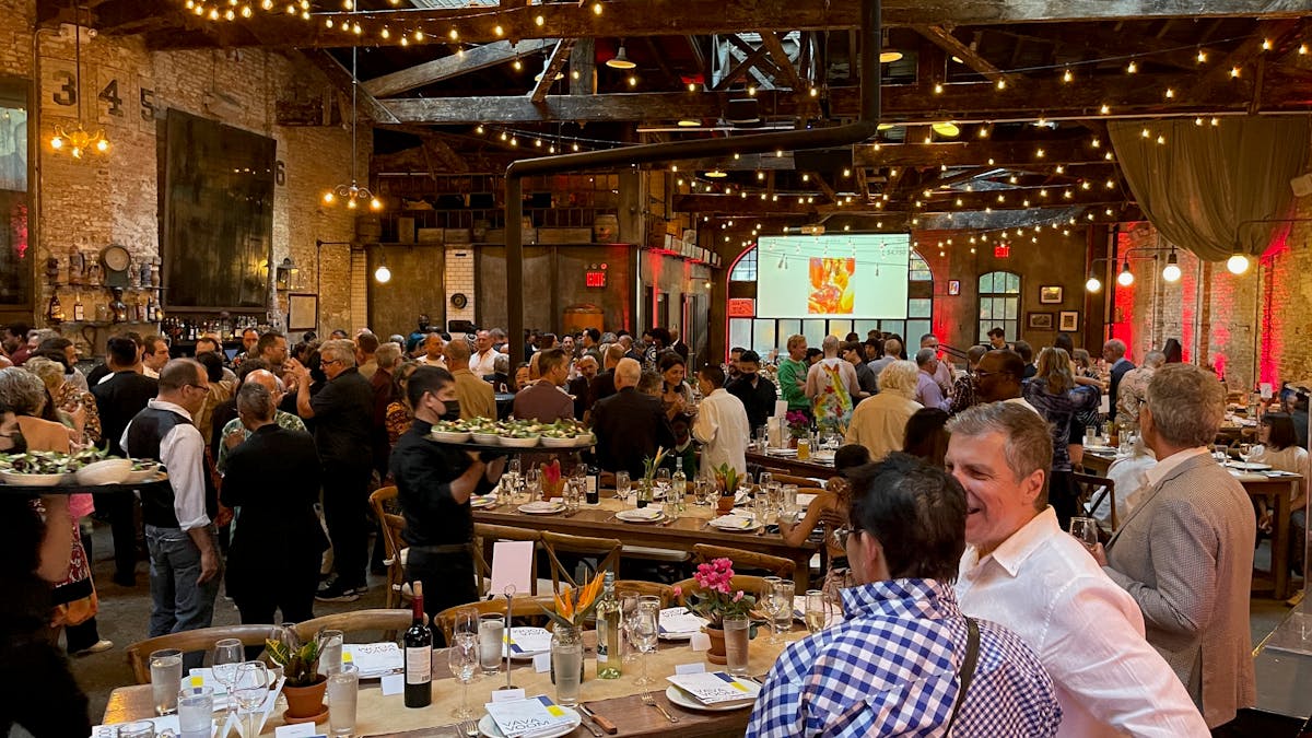 a beer hall with people and tables